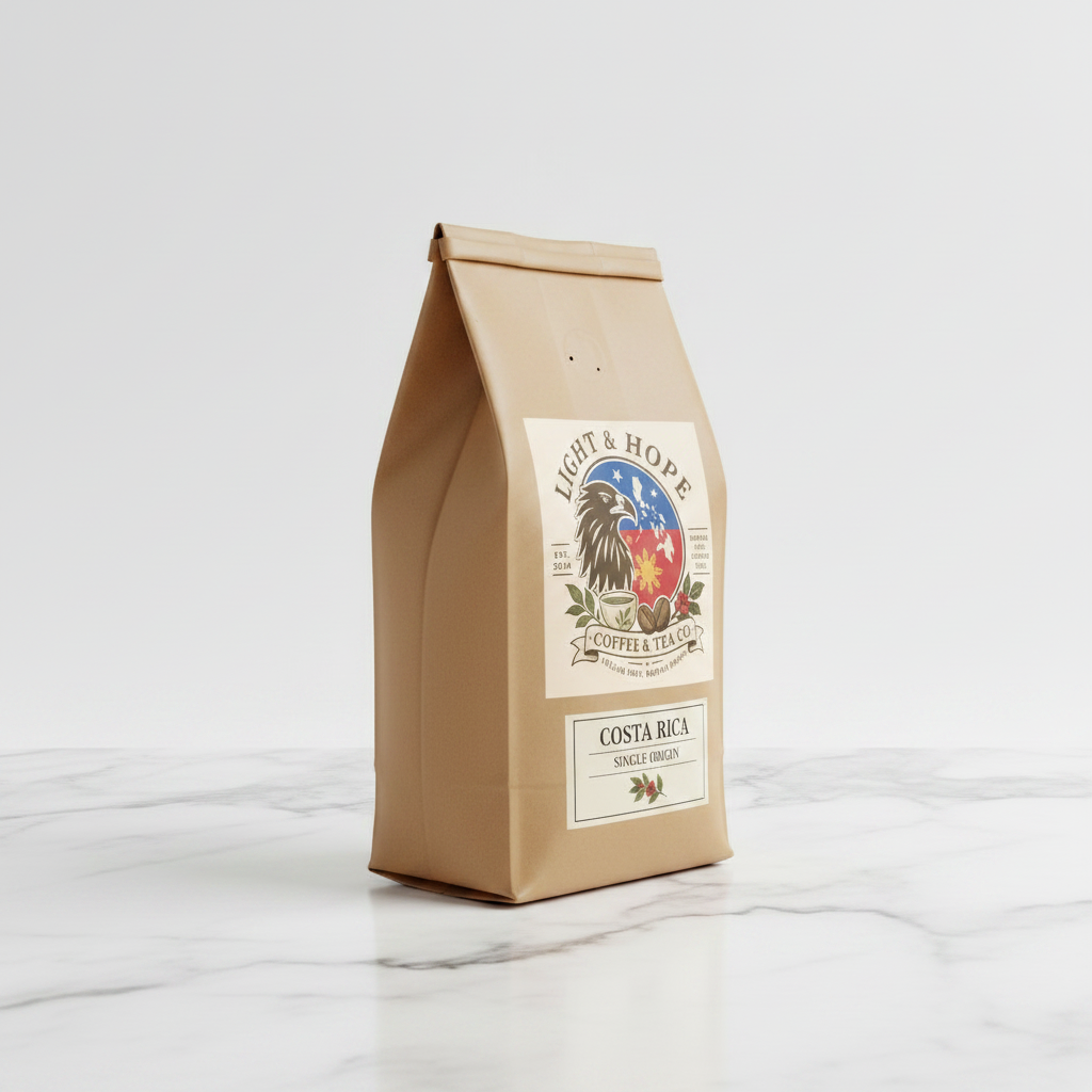 Light & Hope Coffee & Tea Co. Costa Rica single origin coffee bag side angle on white marble, clean minimalist premium product photography